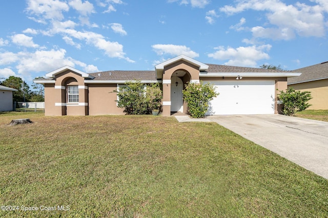 ranch-style home featuring stucco siding, a front yard, and driveway