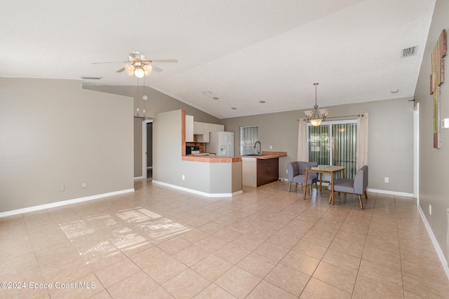 unfurnished living room with visible vents, a ceiling fan, a sink, baseboards, and lofted ceiling