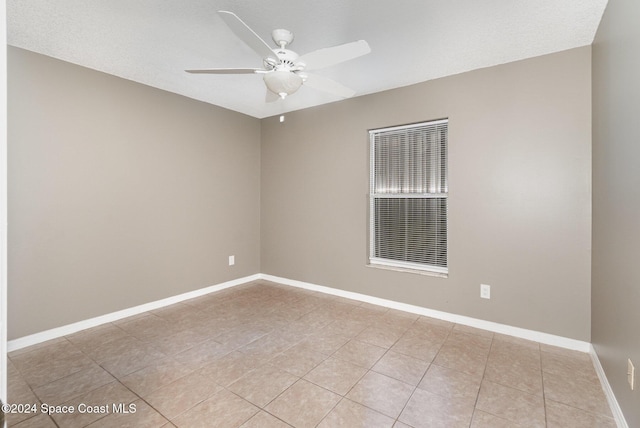 empty room with baseboards and ceiling fan