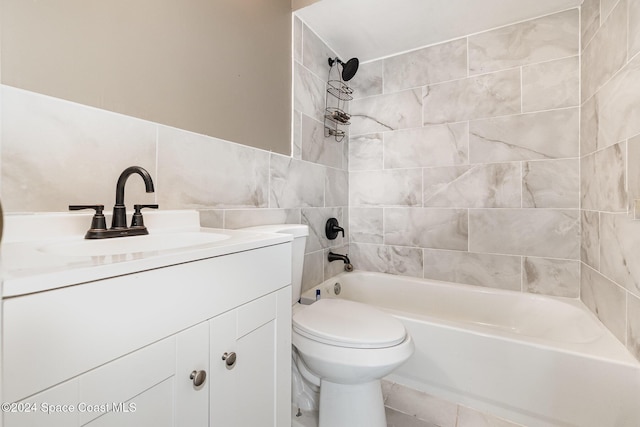 bathroom with toilet, vanity, and  shower combination