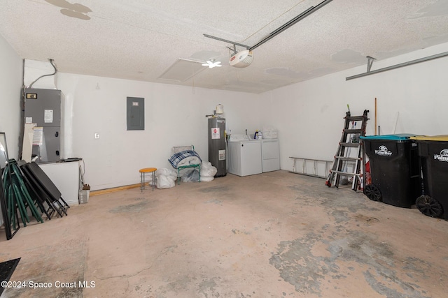 garage with washing machine and clothes dryer, electric water heater, a garage door opener, and electric panel