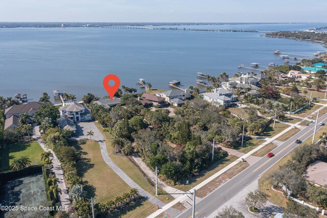 drone / aerial view with a residential view and a water view