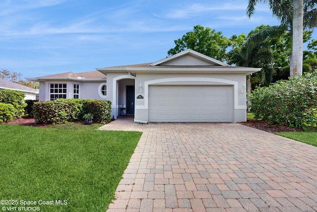 ranch-style house with stucco siding, decorative driveway, a garage, and a front lawn