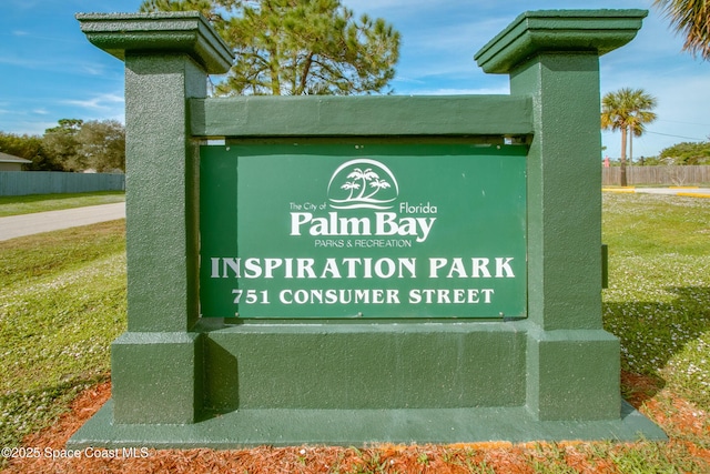 community / neighborhood sign with a lawn