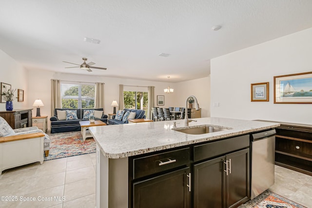 kitchen featuring dishwasher, open floor plan, a kitchen island with sink, and a sink