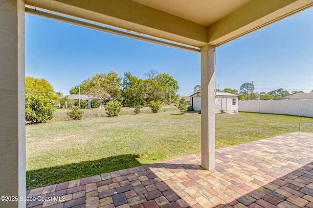 view of patio featuring an outdoor structure, a storage unit, and fence