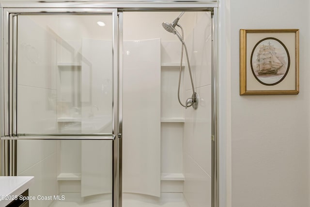 full bathroom with vanity and a shower stall