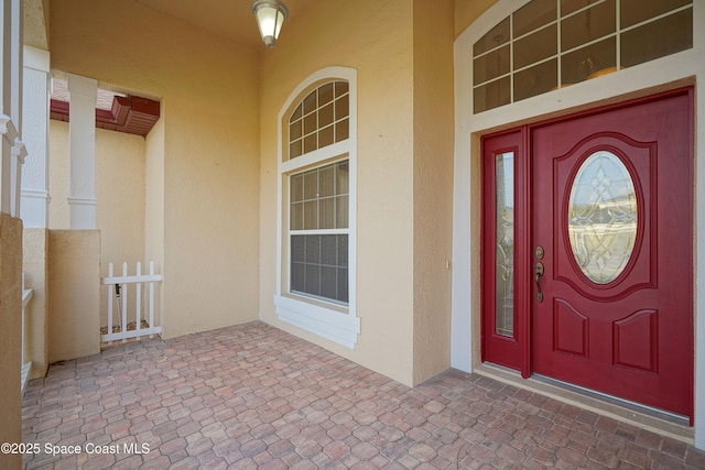 property entrance featuring stucco siding