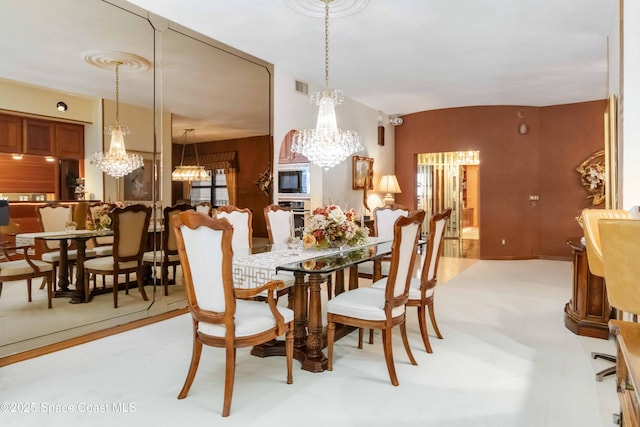 dining space featuring visible vents and a chandelier