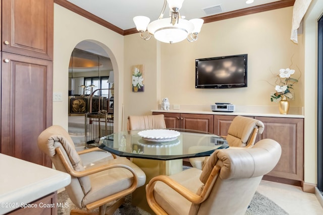 dining space with visible vents, arched walkways, and crown molding