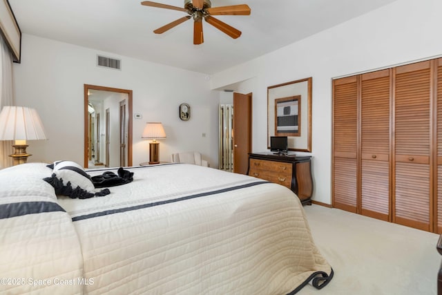 bedroom with baseboards, visible vents, ceiling fan, a closet, and light carpet