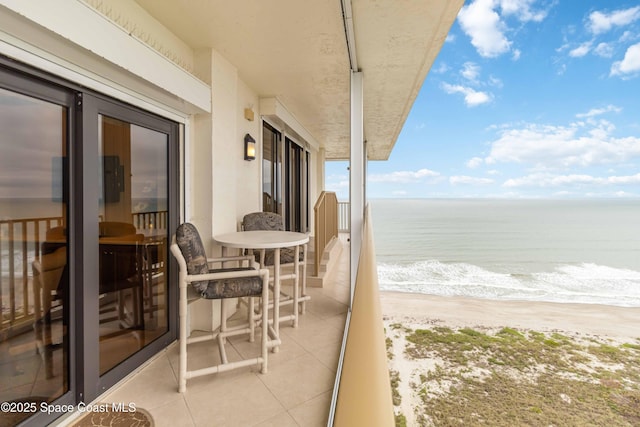 balcony with a view of the beach and a water view