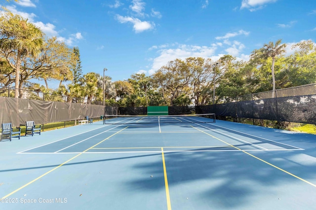 view of tennis court featuring fence