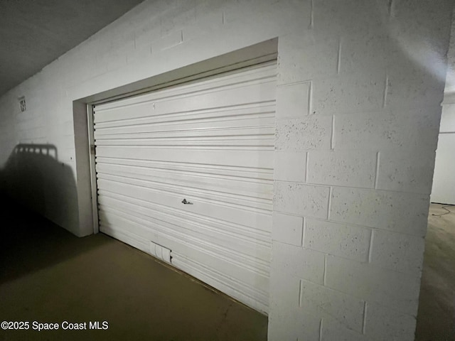 garage with concrete block wall