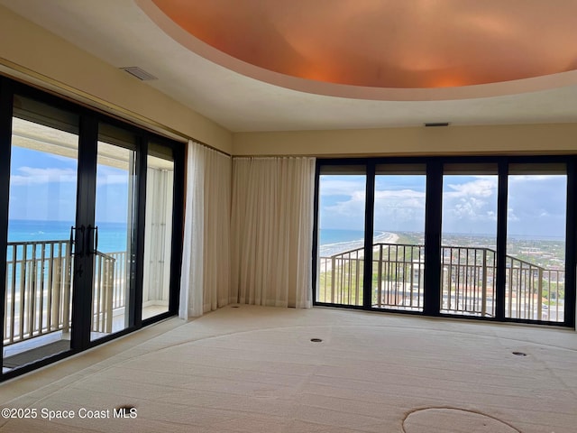 750 N Atlantic Ave Ph 4, Cocoa Beach, FL 32931 - spare room featuring a water view, carpet floors, healthy amount of natural light, and french doors