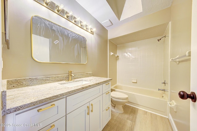 full bathroom with vanity, toilet, wood finished floors, and  shower combination