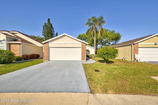 ranch-style home with an outbuilding, concrete driveway, brick siding, and a front lawn