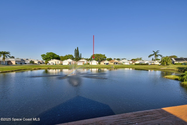 dock area with a residential view and a water view