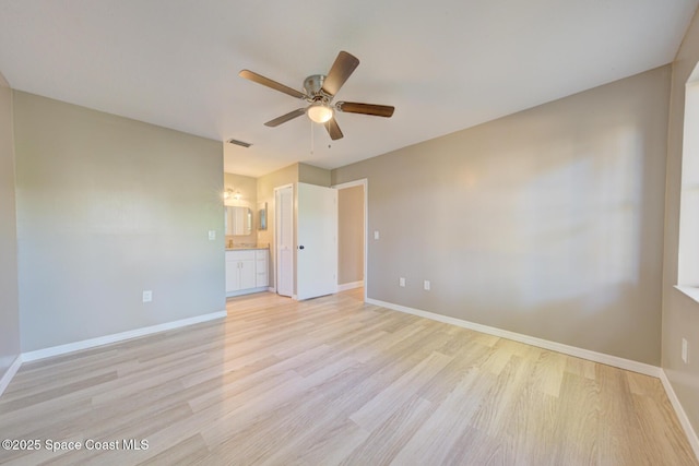 spare room with visible vents, baseboards, light wood finished floors, and ceiling fan