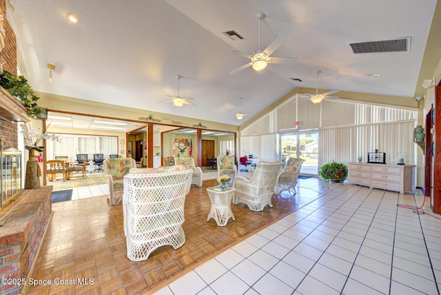 living area featuring visible vents, high vaulted ceiling, ceiling fan, and tile patterned flooring