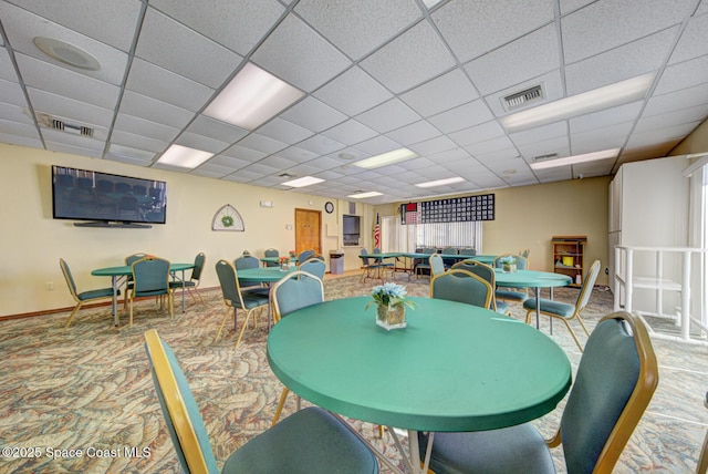 dining room with visible vents, a paneled ceiling, baseboards, and carpet floors