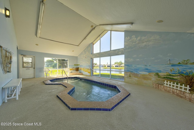 view of pool featuring an indoor hot tub and a water view