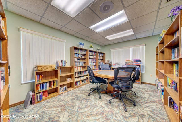 office featuring a paneled ceiling and baseboards