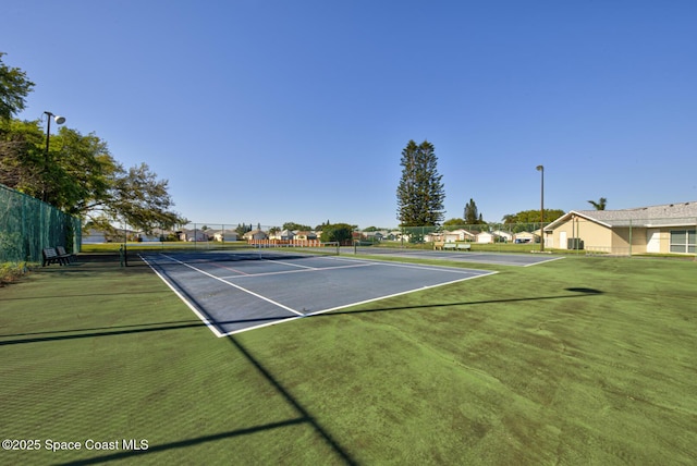 view of sport court featuring fence