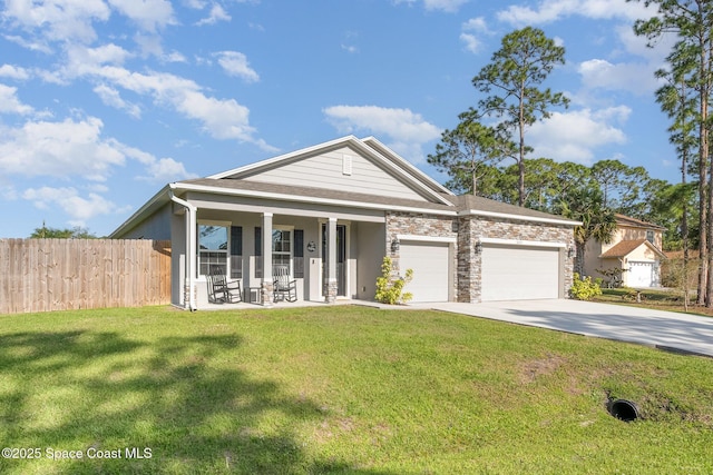 view of front facade featuring driveway, an attached garage, a front yard, and fence