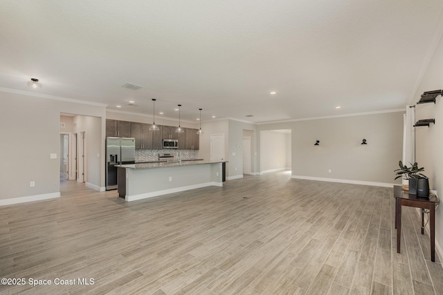 unfurnished living room with visible vents, light wood-style flooring, and baseboards