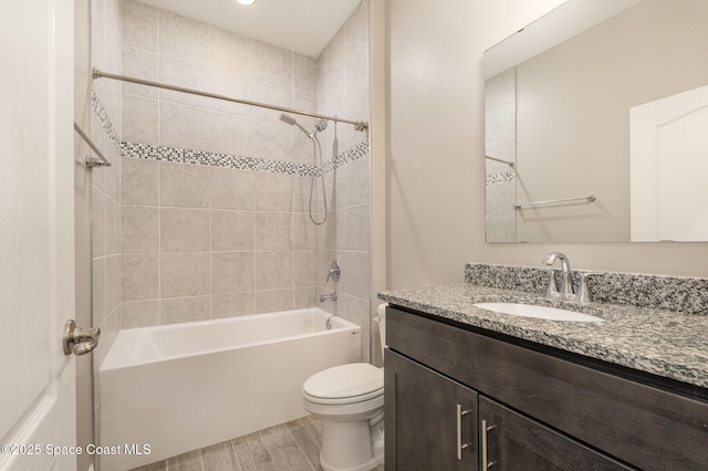 full bath featuring wood finished floors, toilet, shower / washtub combination, and vanity