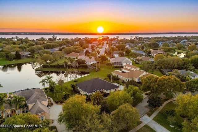 drone / aerial view featuring a residential view and a water view