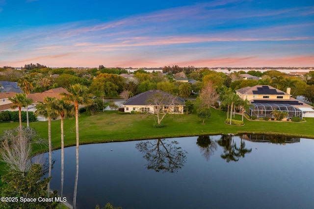 aerial view at dusk with a water view