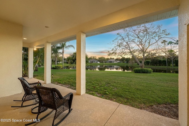 view of patio with a water view