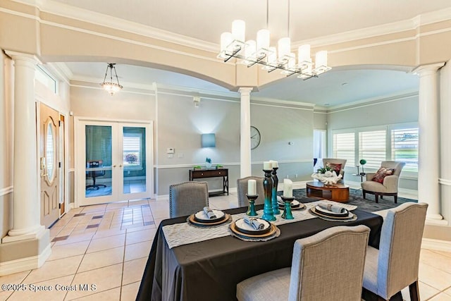 dining space featuring light tile patterned floors, arched walkways, crown molding, and decorative columns