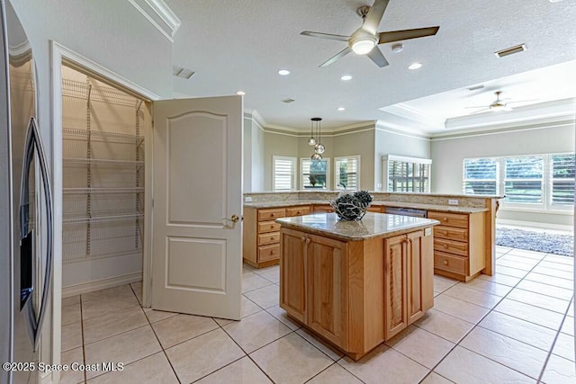 kitchen featuring light tile patterned floors, appliances with stainless steel finishes, crown molding, and a ceiling fan