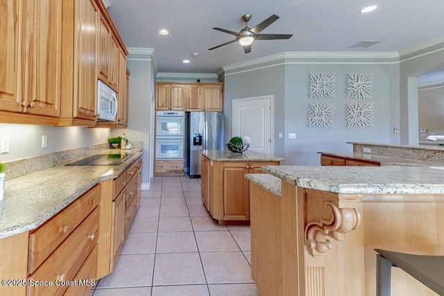 kitchen featuring white appliances, a kitchen island, light tile patterned flooring, and ornamental molding