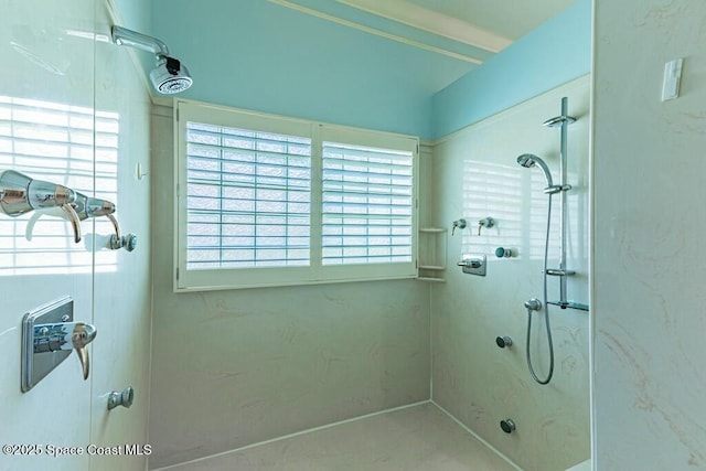 bathroom featuring a marble finish shower