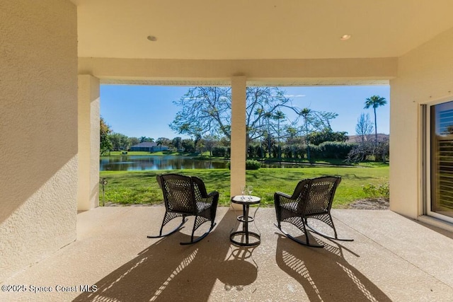 view of patio featuring a water view