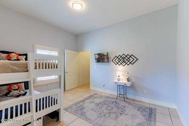 tiled bedroom featuring baseboards