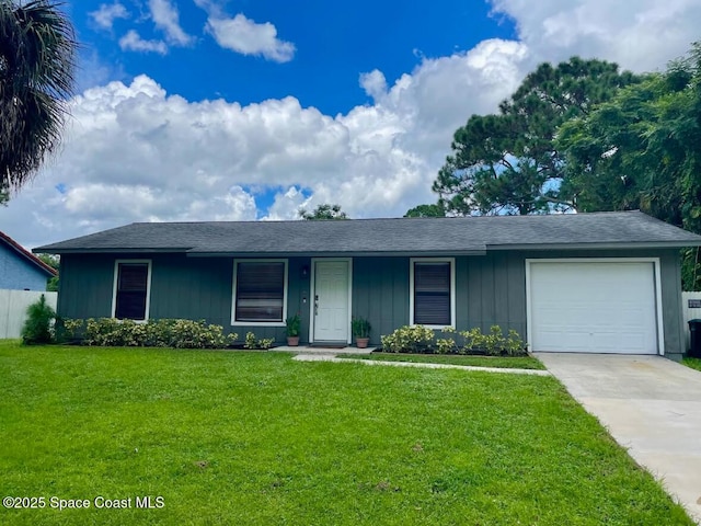 single story home with driveway, an attached garage, a front yard, and fence