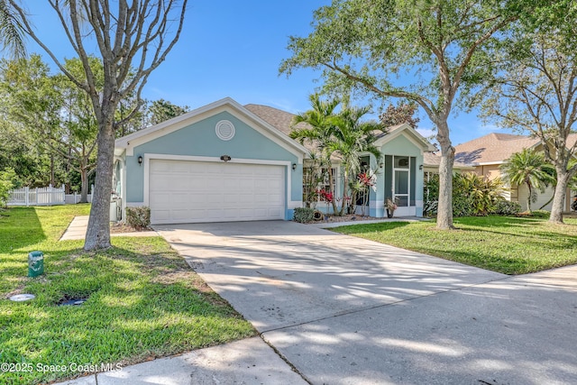 view of front of house featuring a front yard, fence, driveway, stucco siding, and a garage