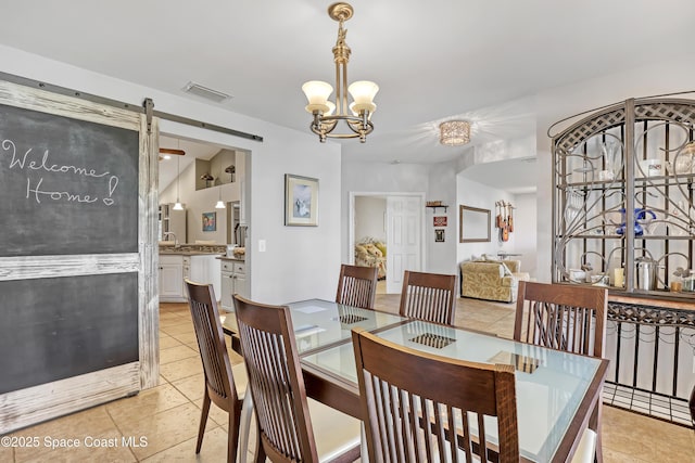 dining area with light tile patterned floors, visible vents, and a chandelier