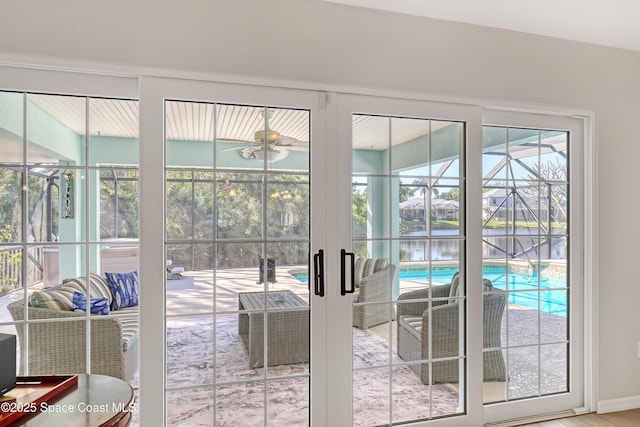 doorway featuring french doors, a water view, and a sunroom