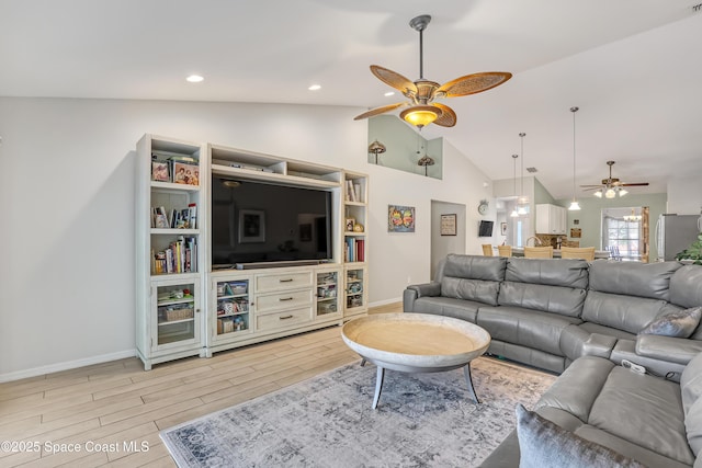 living area featuring light wood finished floors, baseboards, lofted ceiling, and a ceiling fan