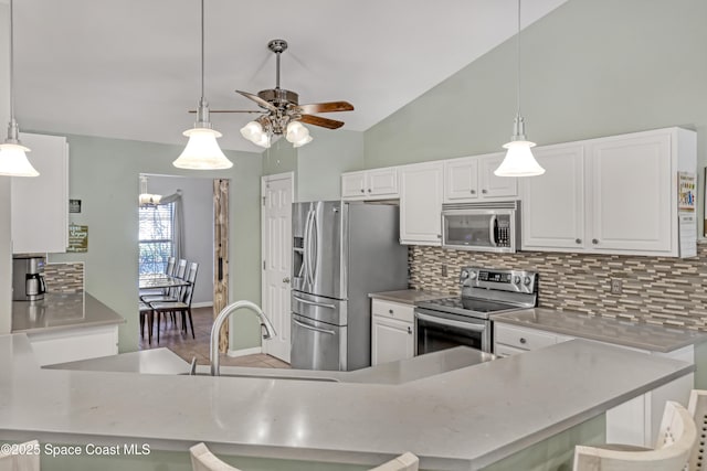 kitchen with stainless steel appliances, backsplash, ceiling fan, and white cabinets