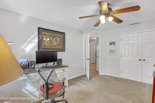 office space featuring baseboards, light colored carpet, visible vents, and ceiling fan