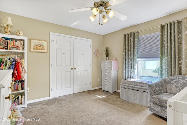 sitting room with carpet flooring, a ceiling fan, and baseboards