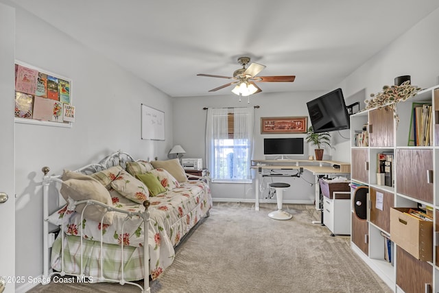 carpeted bedroom featuring baseboards and a ceiling fan