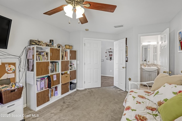 bedroom featuring visible vents, carpet floors, a sink, ceiling fan, and connected bathroom